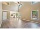 Open-concept living space with hardwood floors, high ceilings, and natural light flowing into the connected kitchen at 1745 Fairburn Dr, Cumming, GA 30040