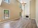 Spacious living room featuring high ceilings, large windows, hardwood floors, and a cozy fireplace at 1745 Fairburn Dr, Cumming, GA 30040