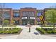View of a shopping center with brick facade and well-maintained landscaping, offering shopping and dining options at 1745 Fairburn Dr, Cumming, GA 30040