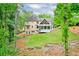 Spacious backyard with lush greenery, covered patio, and well-maintained lawn perfect for outdoor activities at 305 High Branch Way, Roswell, GA 30075