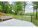 Backyard patio with a seating area overlooking the lush greenery leading down to the water at 305 High Branch Way, Roswell, GA 30075