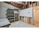 Unfinished basement area featuring a pegboard, shelfing and concrete foundation at 305 High Branch Way, Roswell, GA 30075