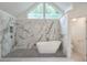 Modern bathroom boasting a soaking tub with marble accent wall, and decorative leaded-glass window at 305 High Branch Way, Roswell, GA 30075