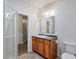 Bathroom with granite counters, warm wood cabinets, and walk-in shower at 305 High Branch Way, Roswell, GA 30075