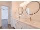 Bright bathroom features marble countertops with double sinks, round mirrors, and modern fixtures at 305 High Branch Way, Roswell, GA 30075