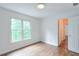 Inviting bedroom with hardwood floors and natural light from two windows at 305 High Branch Way, Roswell, GA 30075