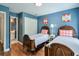 Comfortable bedroom featuring two beds, hardwood floors, and a view to an adjacent bathroom at 305 High Branch Way, Roswell, GA 30075