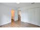 Bright bedroom featuring hardwood floors, closet, and en suite bathroom with a white vanity at 305 High Branch Way, Roswell, GA 30075