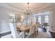 Open-concept dining area with hardwood floors and elegant furnishings, adjacent to the living room at 305 High Branch Way, Roswell, GA 30075