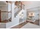 Elegant foyer with a staircase, hardwood floors, and view of a formal sitting area at 305 High Branch Way, Roswell, GA 30075