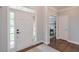 Welcoming foyer with hardwood floors, light gray walls, and a glimpse into other rooms at 305 High Branch Way, Roswell, GA 30075