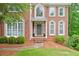 Detailed view of the home's entrance, showcasing the brick facade and manicured landscaping at 305 High Branch Way, Roswell, GA 30075