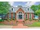 Charming brick home featuring a landscaped front yard and a welcoming entrance, creating great curb appeal at 305 High Branch Way, Roswell, GA 30075
