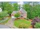 Traditional brick home with a well-manicured lawn and a two-car garage at 305 High Branch Way, Roswell, GA 30075