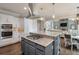 Charming kitchen features stainless steel appliances, a central island, and an adjacent dining area at 305 High Branch Way, Roswell, GA 30075