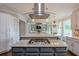 Modern kitchen island boasts a cooktop and stylish vent hood, enhancing functionality and elegance at 305 High Branch Way, Roswell, GA 30075