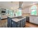 Spacious kitchen with a large island, stainless steel appliances, and a view of the living area at 305 High Branch Way, Roswell, GA 30075