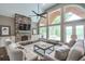 Inviting living room with stone fireplace, large windows, and natural light, a perfect gathering space at 305 High Branch Way, Roswell, GA 30075