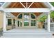 Covered patio area with high ceiling, ceiling fan, gas grill, and plenty of seating, perfect for outdoor entertaining at 305 High Branch Way, Roswell, GA 30075