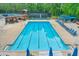 A large community pool featuring lap lanes and lounge chairs under blue canopies for relaxation at 305 High Branch Way, Roswell, GA 30075