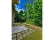 The home features a cozy patio and grassy backyard bordered by mature trees, offering a private outdoor retreat at 4832 Batiste Nw Ln, Acworth, GA 30101