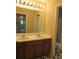 Bathroom with dual sinks, white countertops, wood cabinets, and decorative starburst tile floor at 4832 Batiste Nw Ln, Acworth, GA 30101
