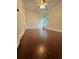 An empty room features hardwood floors, a ceiling fan, and a window with natural light at 4832 Batiste Nw Ln, Acworth, GA 30101