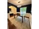 Well-appointed dining room with stylish lighting, blue walls, and a light rug for comfortable Gathering dinners at 4832 Batiste Nw Ln, Acworth, GA 30101
