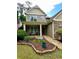 Inviting home exterior with stone accents, well-maintained landscaping, and a cozy front porch at 4832 Batiste Nw Ln, Acworth, GA 30101