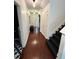 Hallway featuring hardwood floors, white trim, and staircase access to the second floor at 4832 Batiste Nw Ln, Acworth, GA 30101