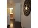 A hallway with wood floors and decorative wall art leads to the bathroom, showcasing the home's interior at 4832 Batiste Nw Ln, Acworth, GA 30101