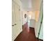 Bright hallway with wood flooring, white doors, and decorative circular wall art at 4832 Batiste Nw Ln, Acworth, GA 30101