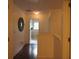 Hallway with wood floors, decorative art, and warm lighting creates a welcoming transition between rooms at 4832 Batiste Nw Ln, Acworth, GA 30101