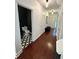 Bright hallway leading to a modern half-bathroom with black and white patterned flooring, adding a unique touch at 4832 Batiste Nw Ln, Acworth, GA 30101