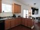Cozy kitchen with wood cabinets, a corner sink, and an adjacent sitting area for seamless living at 4832 Batiste Nw Ln, Acworth, GA 30101