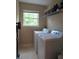 Well-lit laundry room with a side-by-side washer and dryer near a window at 4832 Batiste Nw Ln, Acworth, GA 30101