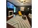 Cozy living room with a modern fireplace, patterned rug, and contemporary furnishings at 4832 Batiste Nw Ln, Acworth, GA 30101