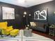 Comfortable living room with a yellow armchair, gray sofa, and stylish decor for a cozy gathering space at 4832 Batiste Nw Ln, Acworth, GA 30101