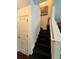 A staircase with dark steps ascends beside a white wall, adding character to the home's interior at 4832 Batiste Nw Ln, Acworth, GA 30101