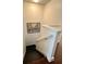 Staircase with white railing and decorative artwork on a neutral-toned wall at 4832 Batiste Nw Ln, Acworth, GA 30101