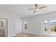 Bright bedroom with wood flooring, neutral paint, and double doors to the outside at 853 Pensive Run, Dacula, GA 30019