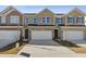 Brick townhome with a two-car garage and long driveway at 853 Pensive Run, Dacula, GA 30019