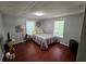 Serene bedroom with wood floors, offering a peaceful retreat with ample natural light and cozy ambiance at 1720 Valley Ln, Cumming, GA 30040