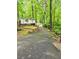 Driveway leading to home, surrounded by lush greenery and brick landscaping at 1720 Valley Ln, Cumming, GA 30040