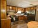 Functional kitchen featuring wood cabinetry, stainless steel appliances, and a practical layout for cooking at 1720 Valley Ln, Cumming, GA 30040