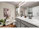 Bright bathroom featuring a double vanity with marble countertops, grey cabinetry, and modern fixtures at 255 Skipjack Ct, Covington, GA 30016