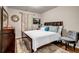 Well-lit bedroom featuring hardwood floors, stylish neutral decor, and a comfortable bed at 255 Skipjack Ct, Covington, GA 30016