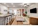 Open-concept living room featuring a modern kitchen island with bar seating and hardwood flooring at 255 Skipjack Ct, Covington, GA 30016