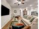 Comfortable living room featuring hardwood floors, stylish furniture, and a large mounted TV at 255 Skipjack Ct, Covington, GA 30016
