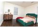 Cozy bedroom with hardwood floors, soft natural light, and a comfortable bed in a neutral color palette at 2576 Flat Shoals Dr, Decatur, GA 30034